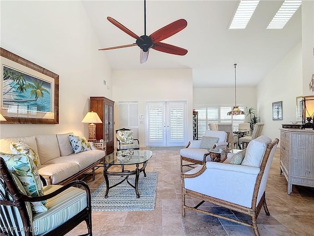 living room featuring ceiling fan and high vaulted ceiling