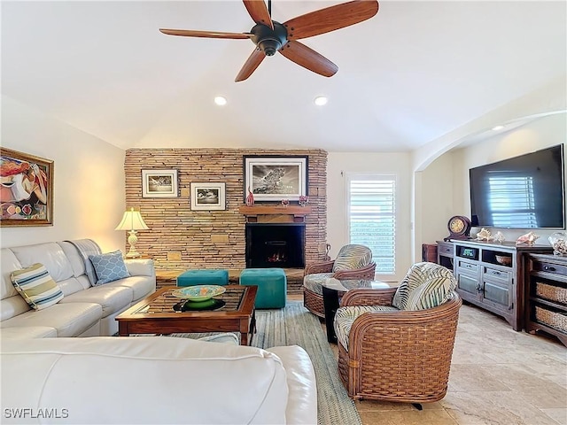 living room featuring lofted ceiling, ceiling fan, and a brick fireplace