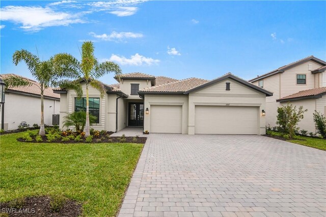 view of front of home featuring a front lawn and a garage