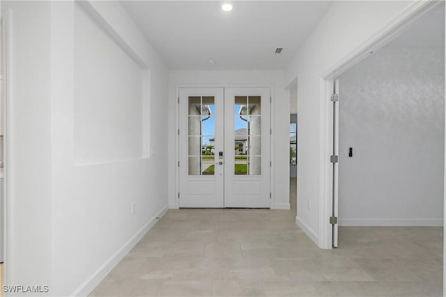 doorway featuring recessed lighting, visible vents, baseboards, and french doors