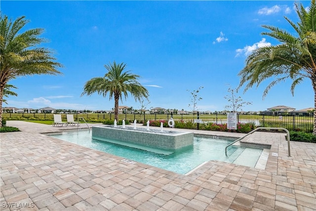 view of pool featuring fence