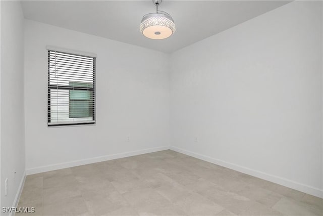 empty room featuring baseboards