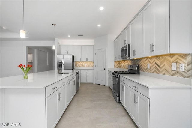 kitchen featuring a large island, pendant lighting, stainless steel appliances, and light countertops