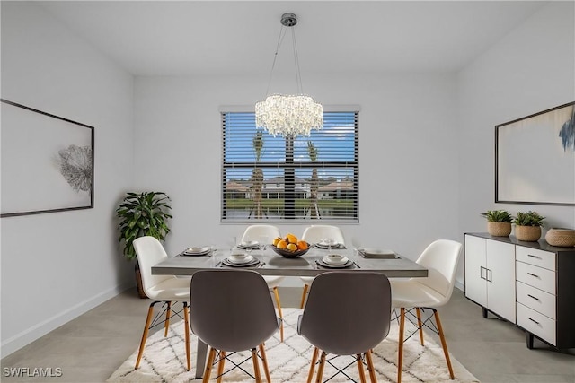 dining area with a chandelier and baseboards