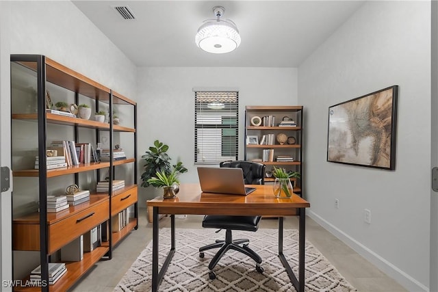 office area with visible vents and baseboards