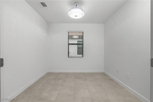 unfurnished room with visible vents and baseboards