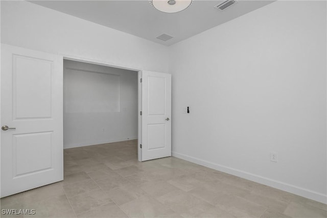 unfurnished bedroom with visible vents and baseboards