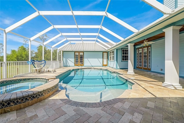 view of swimming pool with glass enclosure, french doors, an in ground hot tub, ceiling fan, and a patio area