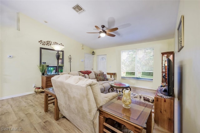 living room featuring ceiling fan, vaulted ceiling, and light hardwood / wood-style flooring