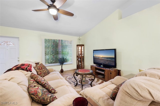 living room featuring lofted ceiling, hardwood / wood-style flooring, and ceiling fan