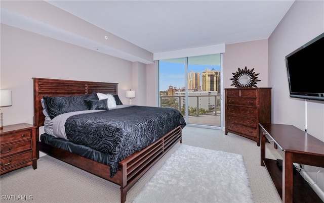 bedroom featuring access to exterior and light colored carpet