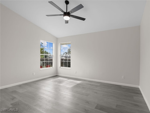 spare room with ceiling fan, wood-type flooring, and vaulted ceiling