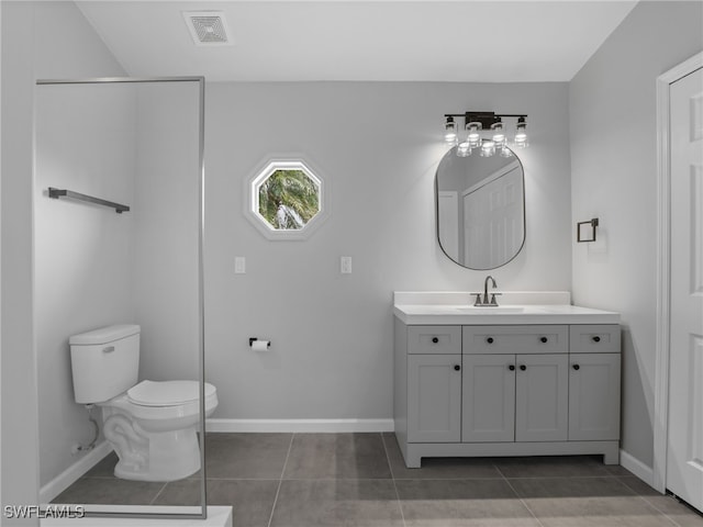 bathroom featuring vanity, toilet, and tile patterned floors