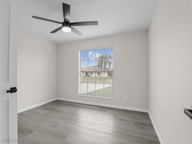 spare room featuring ceiling fan and light hardwood / wood-style flooring