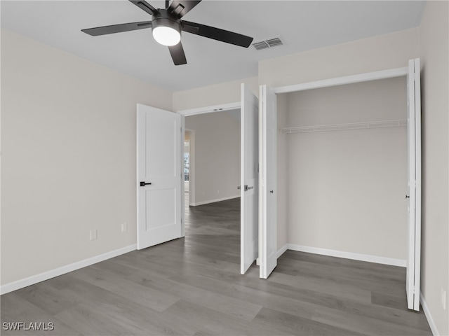 unfurnished bedroom with a closet, ceiling fan, and hardwood / wood-style floors