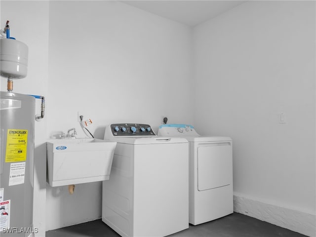 washroom with washer and clothes dryer, sink, and electric water heater