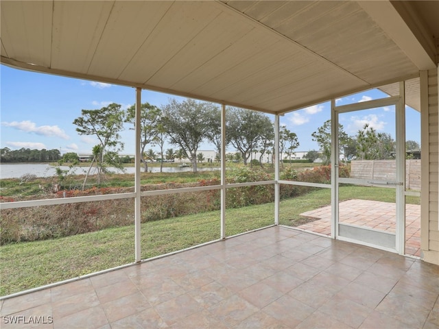 unfurnished sunroom with a water view