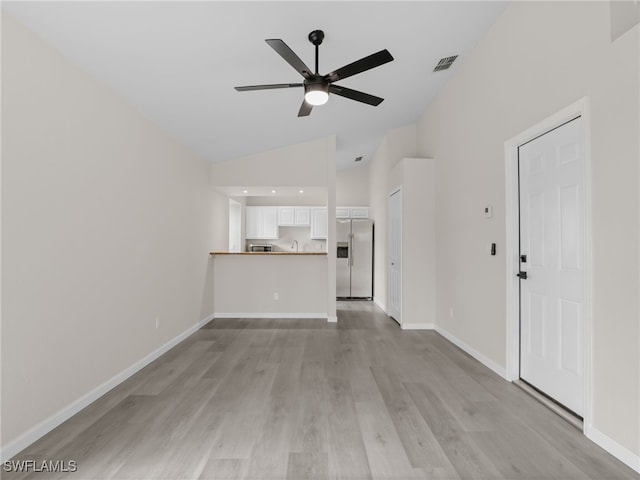 unfurnished living room with vaulted ceiling, ceiling fan, and light hardwood / wood-style flooring