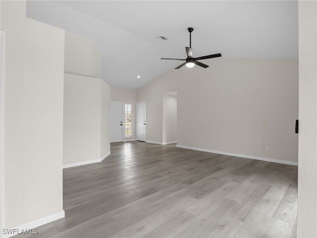 spare room with ceiling fan, high vaulted ceiling, and light wood-type flooring