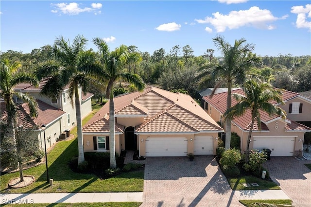 mediterranean / spanish home with a front yard and a garage