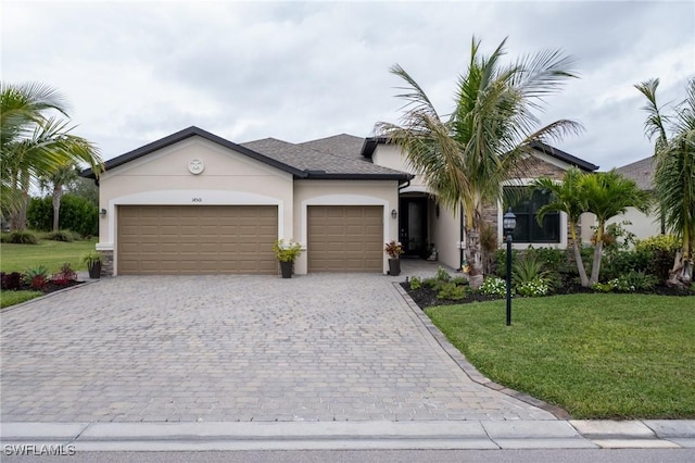 view of front facade featuring a front yard and a garage