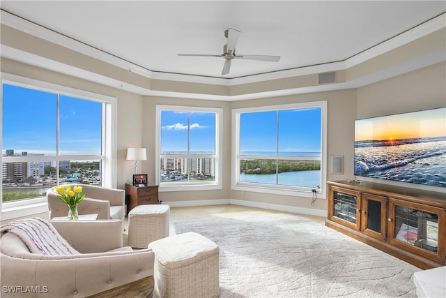 carpeted living room featuring ceiling fan and crown molding