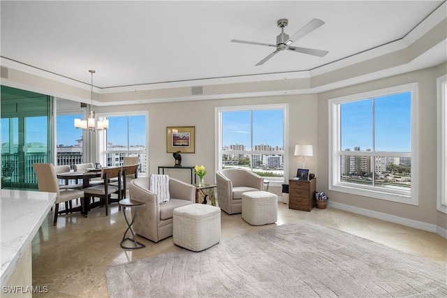 living room with crown molding and ceiling fan with notable chandelier