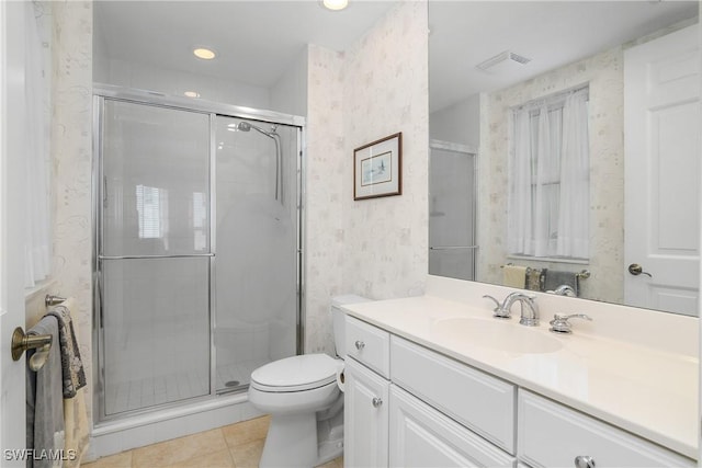 bathroom with toilet, vanity, an enclosed shower, and tile patterned flooring