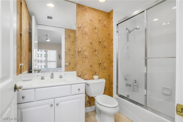 full bathroom with ceiling fan, vanity, toilet, tile patterned flooring, and combined bath / shower with glass door