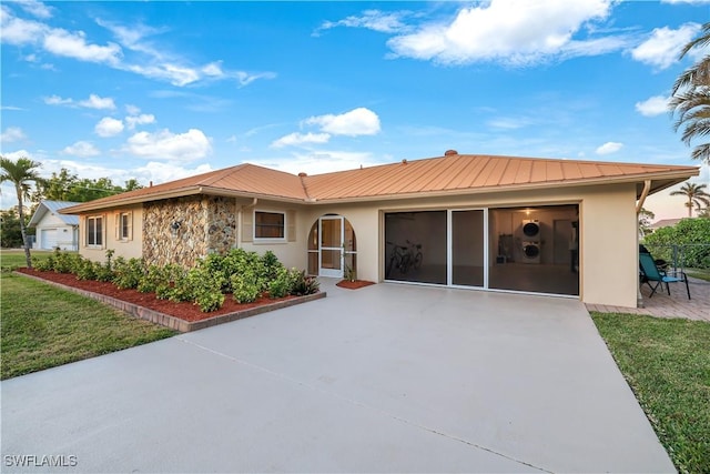 ranch-style home featuring a garage and a front lawn