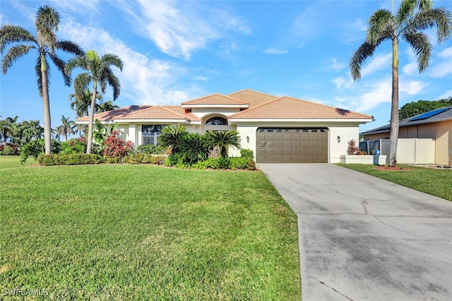 mediterranean / spanish-style home with a front lawn and a garage