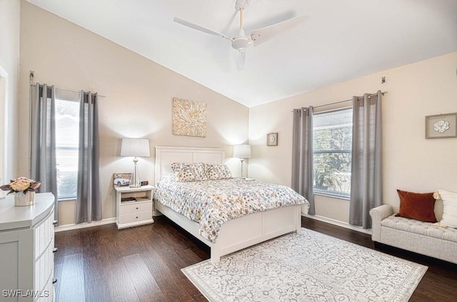 bedroom featuring ceiling fan, dark hardwood / wood-style flooring, vaulted ceiling, and multiple windows