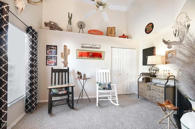 miscellaneous room with a towering ceiling, carpet floors, and ceiling fan