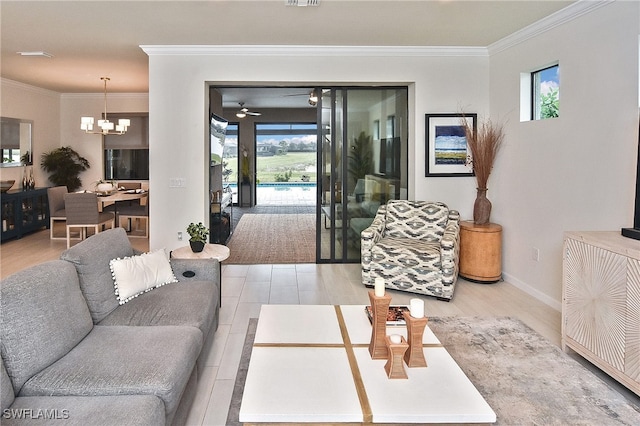 living area featuring plenty of natural light, an inviting chandelier, light wood-style flooring, and crown molding