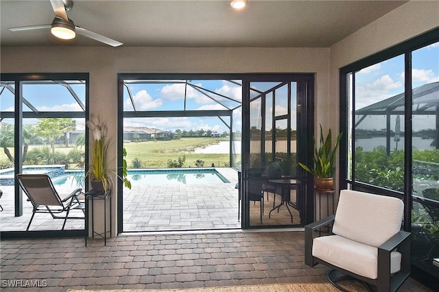 entryway with a water view and ceiling fan