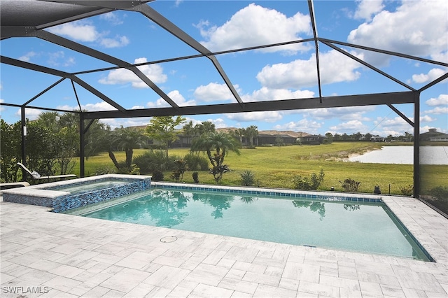 view of swimming pool with glass enclosure, a lawn, a patio area, a water view, and an in ground hot tub