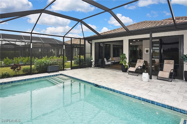 outdoor pool with a lanai and a patio area