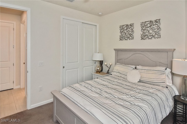 bedroom featuring a closet, baseboards, and carpet floors