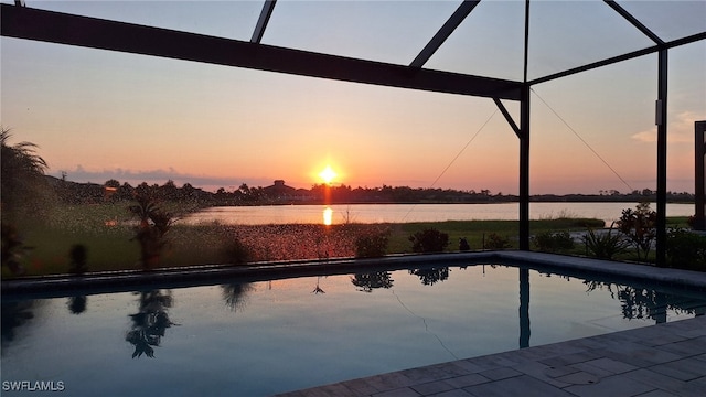 outdoor pool with a water view, a lanai, and a patio area