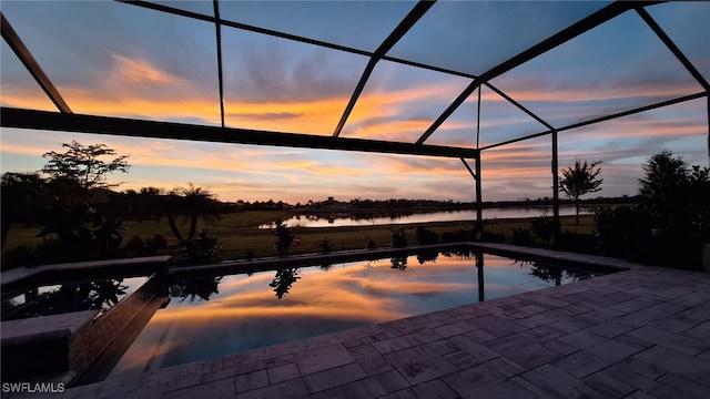 outdoor pool featuring a lanai, a jacuzzi, a patio area, and a water view