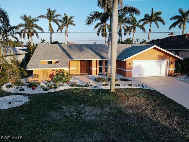 view of front of house with a garage and a front lawn