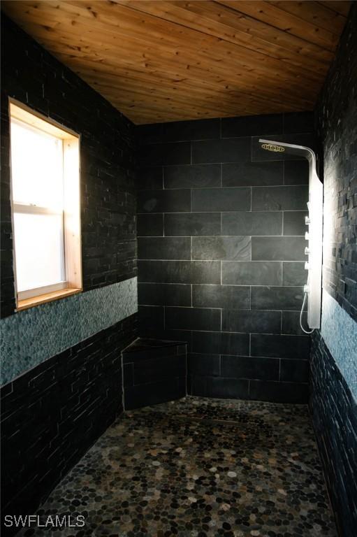 interior space with wooden ceiling and walk in shower