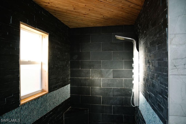 bathroom with vaulted ceiling, wooden ceiling, and walk in shower