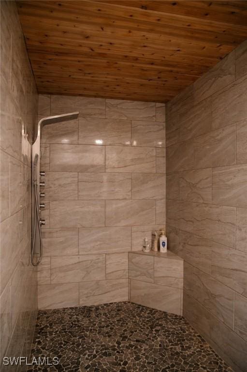 bathroom featuring wood ceiling and tiled shower