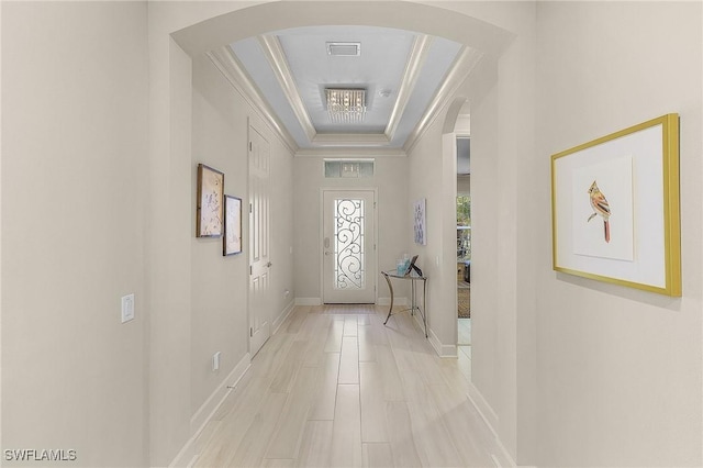 interior space featuring ornamental molding and a tray ceiling