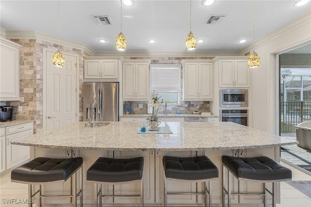 kitchen featuring a large island, appliances with stainless steel finishes, decorative backsplash, hanging light fixtures, and crown molding