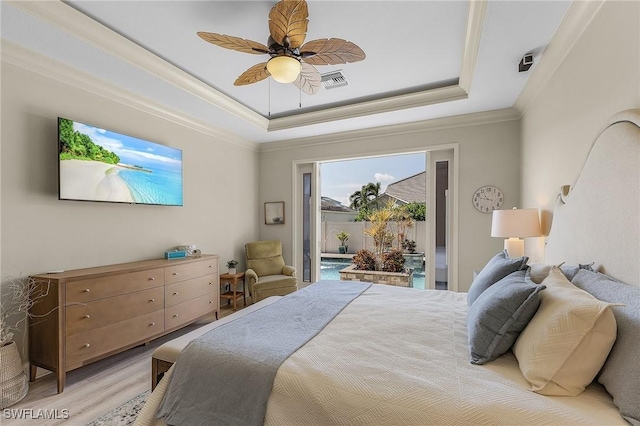 bedroom featuring ornamental molding, access to outside, ceiling fan, a tray ceiling, and light hardwood / wood-style flooring