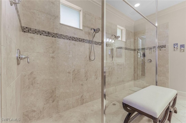 bathroom with tiled shower and ornamental molding