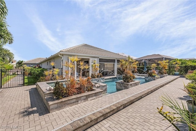 exterior space featuring pool water feature and a patio