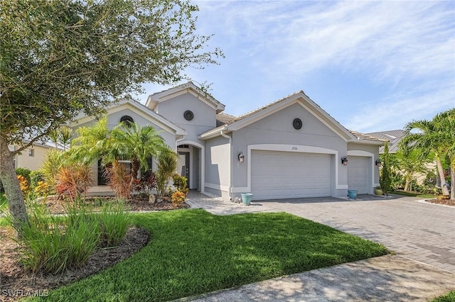 ranch-style home with a garage and a front yard